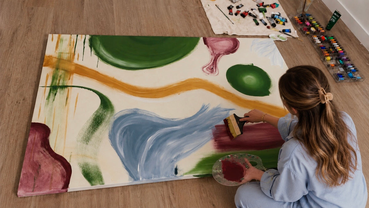 Eugenia working on a painting on the studio floor