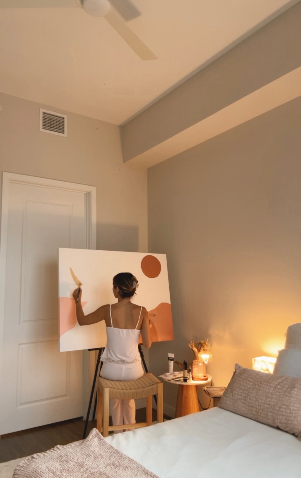 Eugenia painting at her easel in the studio